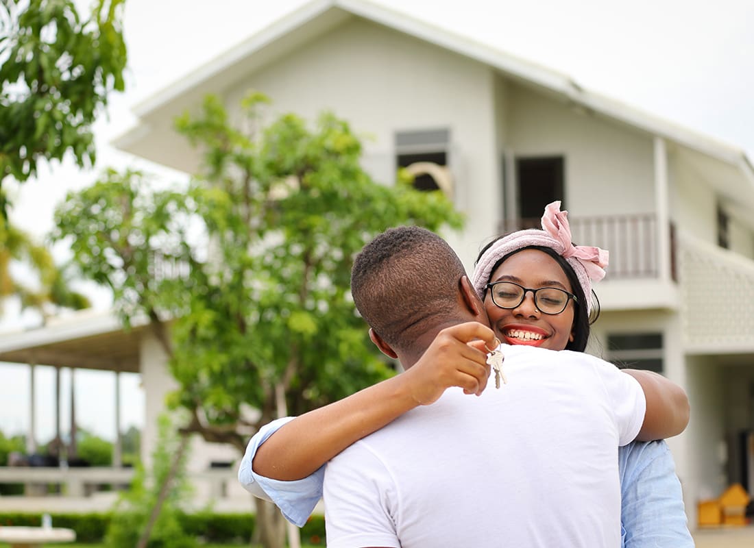 Personal Insurance - Happy Couple Hugging After Buying a Home
